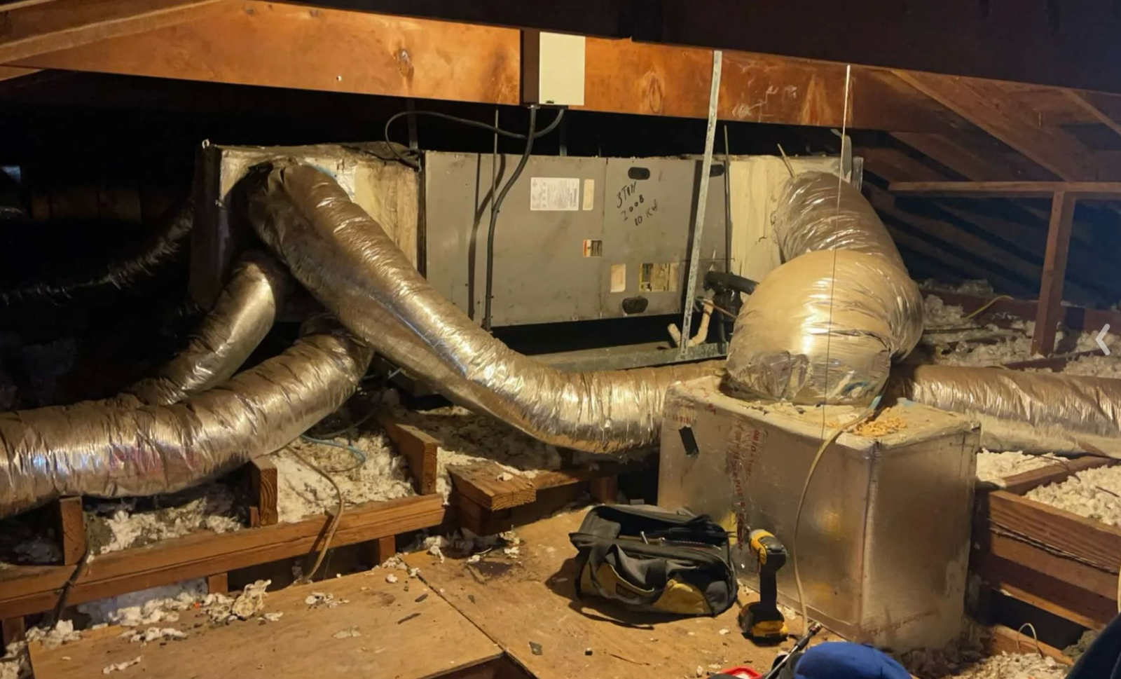 Insulated flexible ductwork installed in the ceiling of a building under construction, designed for efficient HVAC air distribution.